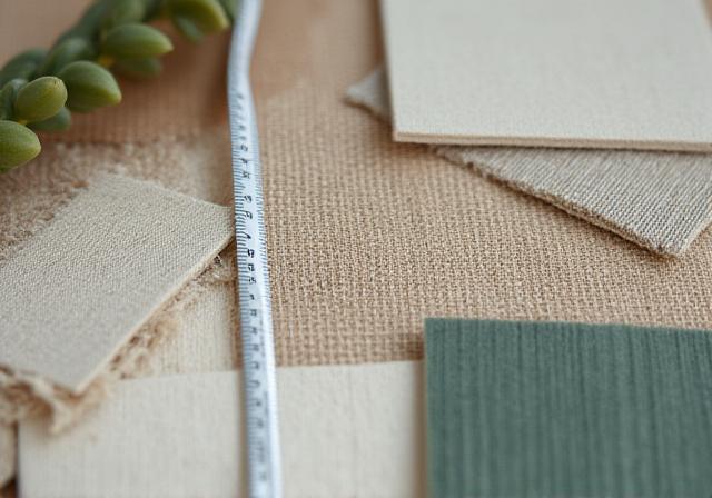 Close up of architectural drawings and sustainable material swatches in the studio